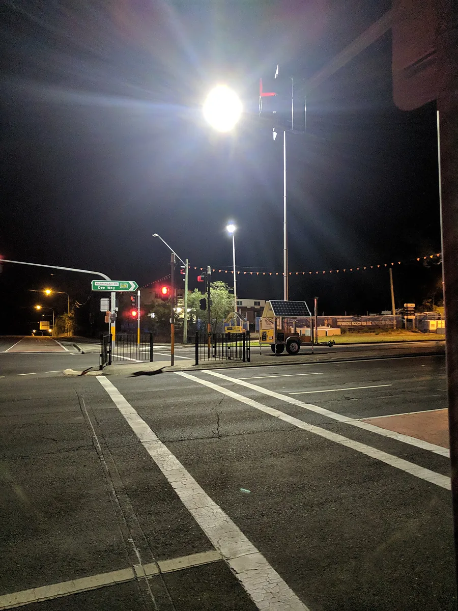 A T Light unit lighting a street intersection at night