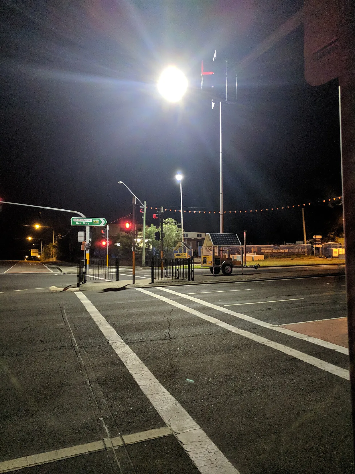 A T Light unit lighting a street intersection at night